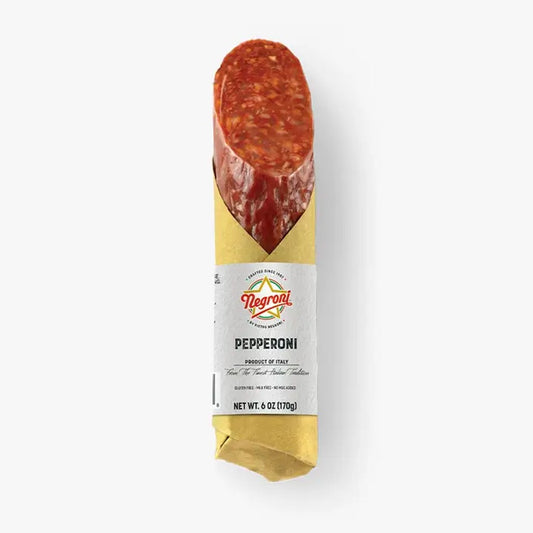 Sliced cured pepperoni sausage with a rich, spiced red interior and smoky seasoning.